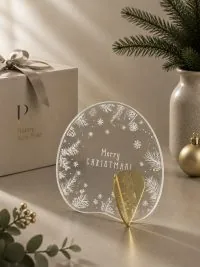 Γούρι Aurora Merry Xmas 02 με νιφάδες, φυτικά στοιχεία και συμμετρική λευκή εικονογράφηση.
